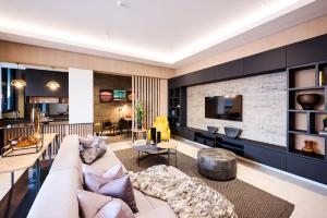 a living room with a couch and a tv at Ellipse Waterfall Executive Apartments in Midrand