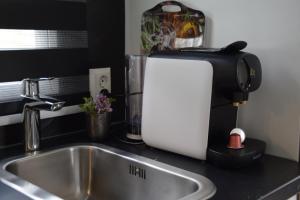 a mixer sitting on a kitchen counter next to a sink at 30, Holiday Inn Oisterwijk #Hygiëne #Airport Eindhoven #Airco #Bosrijk #Hiking & Biking #Efteling #Safaripark in Oisterwijk +10 photos