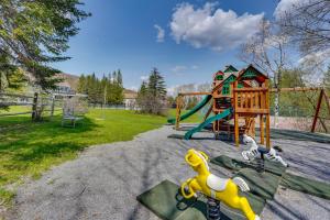 a park with a playground with a slide at Ski-inandSki-Out Peru Condo with Fire Pit and Grill! in Peru