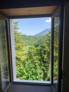 a window with a view of a mountain view at Agriturismo Al Vecio Caselo (Casa Maga) in Arsiero