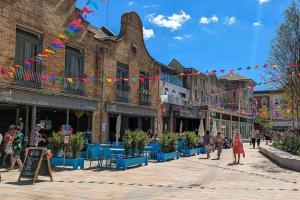 a group of people walking down a street with bunting at Stunning seaside studio in Worthing