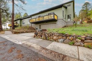 a house with a stone retaining wall and a balcony at Spacious Flagstaff Vacation Rental - 1 Mi to Dtwn in Flagstaff