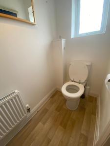 a bathroom with a toilet and a window at Bodmin Rest 4 U in Bodmin