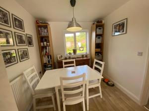 a dining room with a white table and chairs at Bodmin Rest 4 U in Bodmin