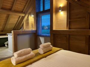 a room with a bed with towels on it at The Hen House - Cosy Retreat, Scenic Countryside 