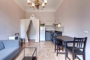 a living room and kitchen with a table and a couch at Ginori 3P in Florence