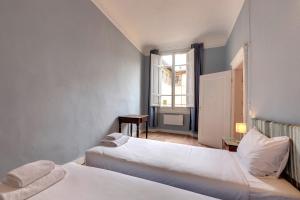 a hotel room with two beds and a window at Ginori 3P in Florence