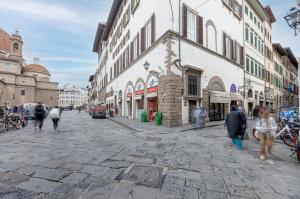 a group of people walking down a street with buildings at Ginori 3P in Florence