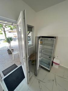 a bathroom with a glass door and a mirror at Müller's 1 in Siófok