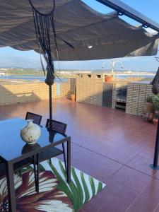 a table with a vase on it on a patio at Apartamento Ruy Belo - Foz in Vila do Conde