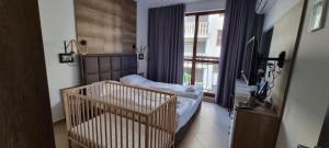 a bedroom with two beds and a window at Deluxe Appartement in Cascadas Resort Sunny Beach in Sunny Beach +77 photos