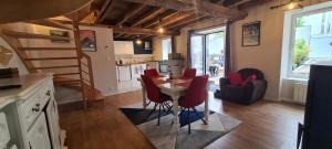 a kitchen and living room with a table and chairs at Gîte de l'Aff in La Gacilly +1 photo
