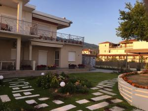 a house with a garden in front of it at Lovely House by the Sea with Garden and BBQ (A) in Platanidia