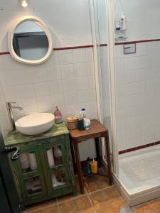 a bathroom with a sink and a shower at Casa idrisi in Albuñuelas +21 photos