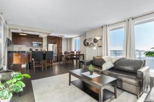 a living room with a couch and a table at Superb 2 bedroom downtown with river view in Saskatoon