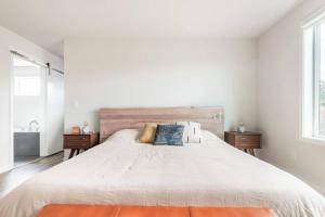 Un dormitorio blanco con una cama grande y una ventana en Comfy Family Home, Walkable Neighborhood + Patio!, en Portland