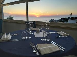 a table with a blue table cloth and wine glasses at Hotel Albatros in Ischia