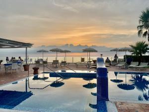 a swimming pool with a view of the ocean at Hotel Albatros in Ischia