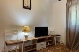 a living room with a desk with a television on it at CASA DRENCOVA SRL in Berzasca