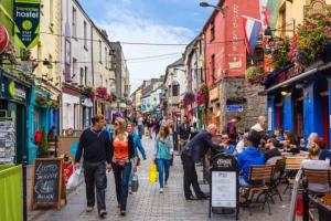 a group of people walking down a city street at Galway City - 135 Bohermore in Galway
