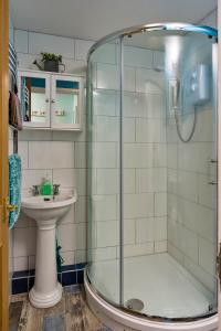 a bathroom with a shower and a sink at Finest Retreats - New Inn Lodge in East Dereham