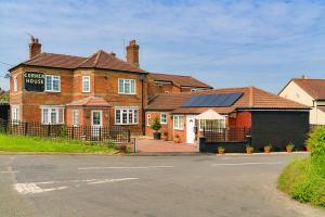 a large brick building with solar panels on it at Finest Retreats - New Inn Lodge in East Dereham