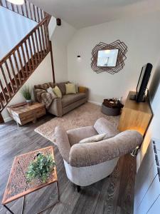 a living room with a couch and a chair at *BRAND NEW* Luxury Country Lodge in Burnham on Crouch