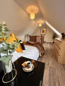 a bedroom with a bed and a table with a coffeeucer at *BRAND NEW* Luxury Country Lodge in Burnham-on-Crouch