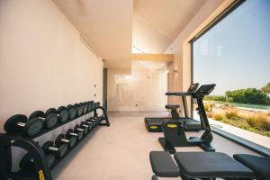 a gym with rows of chairs and a large window at Rakalia Pure Living Sicilian Retreat in Marsala