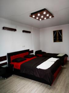 a bedroom with two beds and a ceiling at Kice Apartments in Ohrid