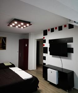 a room with two beds and a flat screen tv at Kice Apartments in Ohrid