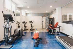 a gym with several treadmills and exercise bikes at Minura Cala Galdana & Apartamentos d'Aljandar in Cala Galdana