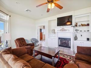 a living room with a couch and a fireplace at Oceanside Paradise in Galveston