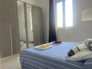 a bedroom with a bed with two towels on it at Roberta House Rozzano 2 in Rozzano