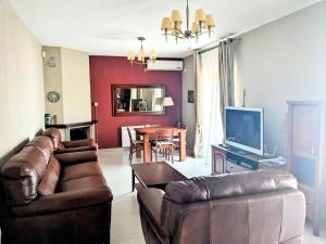 a living room with two leather couches and a table at Serene Sea View Apartments in Utjeha in Utjeha