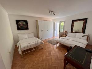 a living room with two beds and a mirror at Adriatic View in Split
