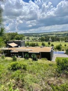 a house in a field with a roof at RaHa Soul Sanctuary - Entire Home in De Deur
