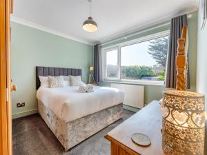 a bedroom with a bed and a large window at Beach Haven - Uk42241 in Littlestone-on-Sea