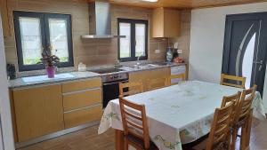 a kitchen with a table with a white table cloth at Casa de Gonçalo in Pinheiro