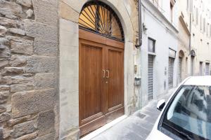 eine Holztür an der Seite eines Gebäudes in der Unterkunft San Niccolò Elegant Apartment in Florenz