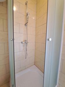 a shower with a glass door in a bathroom at Lifestyle apartment Podstrana in Podstrana +44 photos