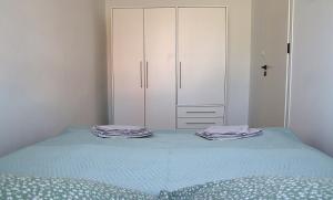 a bedroom with a bed with a white cabinet at Dom Mazury in Piecki