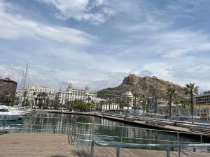 a view of a harbor with a mountain in the background at Bonito bajo con gran terraza in San Juan de Alicante