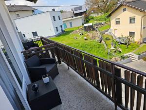 a balcony with a chair and a view of a yard at Orchidea3 in Finkenstein