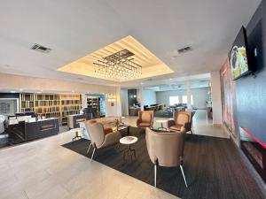 a lobby of a hotel with chairs and tables at La Quinta by Wyndham Decatur in Decatur