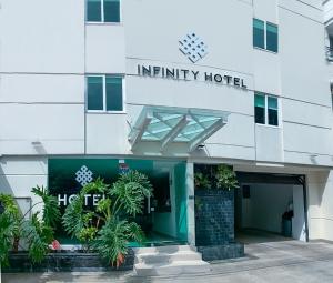 una entrada a un hotel infinito con plantas delante de él en Infinity Hotel, en Medellín