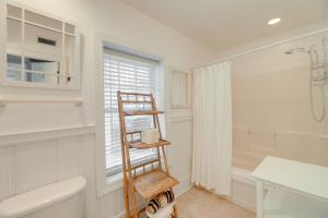 a bathroom with a wooden ladder in a white bathroom at Atlantic Beach Condo - Walk to Beaches! in Atlantic Beach +17 photos