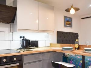 a kitchen with a wooden counter top with a stove top oven at Chyvelyn in Perranporth