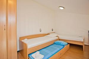 a small bedroom with two beds and a blue mattress at Villa Iva in Kotor