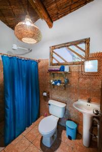 a bathroom with a toilet and a sink at Casa Lavanda in tropical jungle garden in Manzanillo